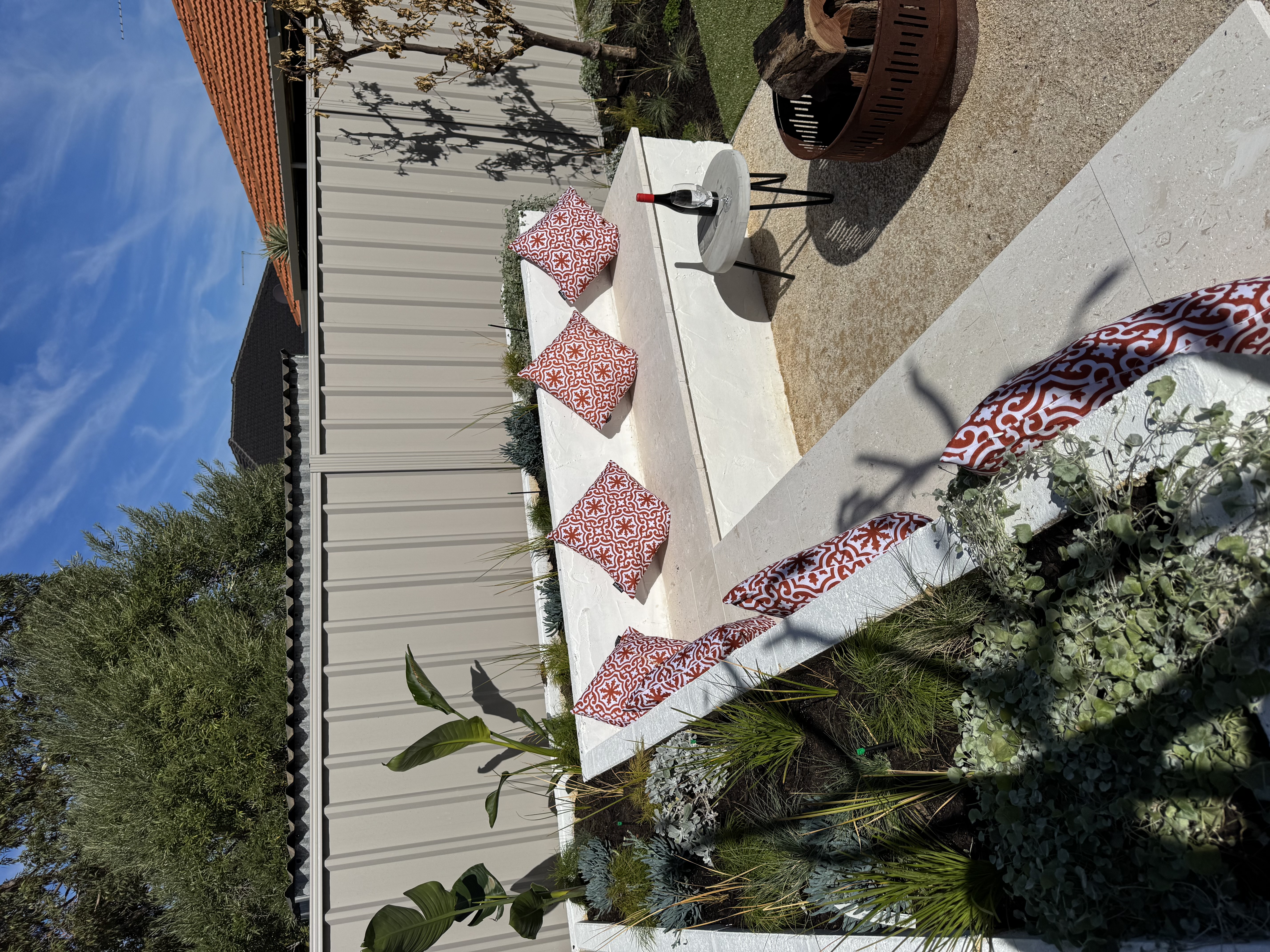 Full backyard transformation with timber decking, stone retaining walls, and garden beds in Perth