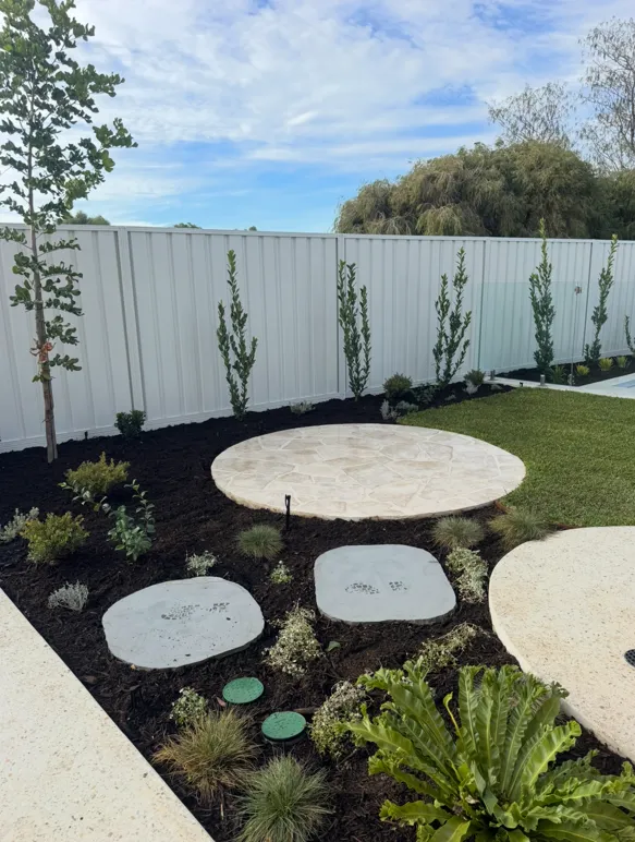 Natural stone pathway winding through layered garden beds