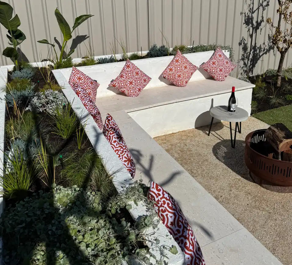 Completed backyard transformation with limestone paving and native planting in Cottesloe