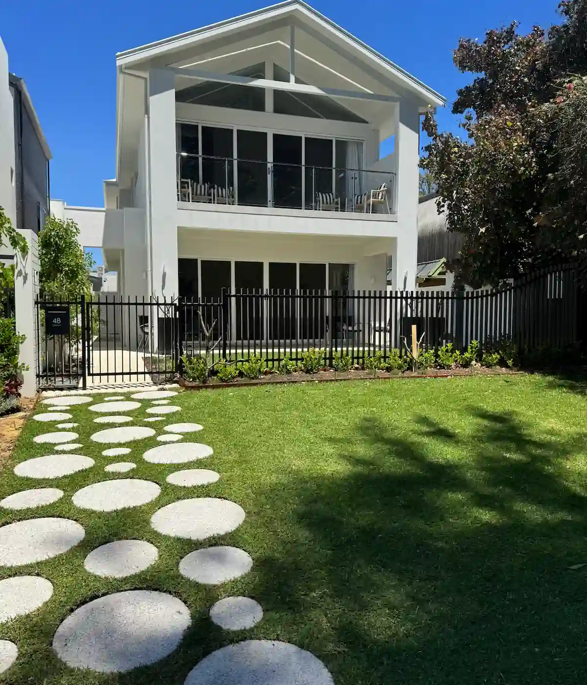 Hardwood timber deck with built-in seating overlooking a coastal garden