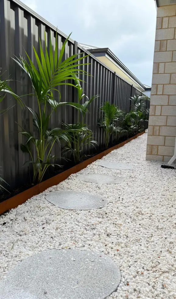 Natural stone pathway winding through layered garden beds